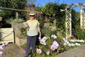 Garden.org.uk Lady looking proud of here garden